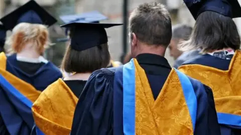 Chris Radburn/PA Media People wearing academic gowns