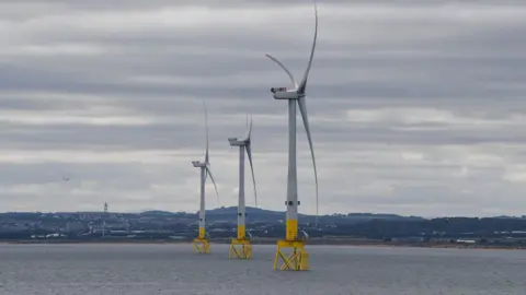 Wind turbines standing on platforms in the sea 