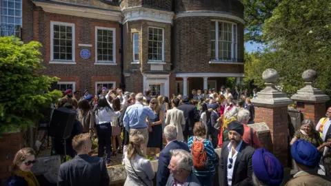 Christopher Ison/English Heritage People in the sunshine underneath Princess Sophia's plaque at Faraday House