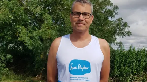 Richard Ostler Richard Ostler wearing a running shirt with Sue Ryder written on it