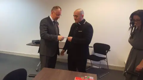 Facebook Former Bulgarian Prime Minister Sergei Stanishev (left) hands Biser Dzhambazov and Katrin Ivanova BSP membership cards