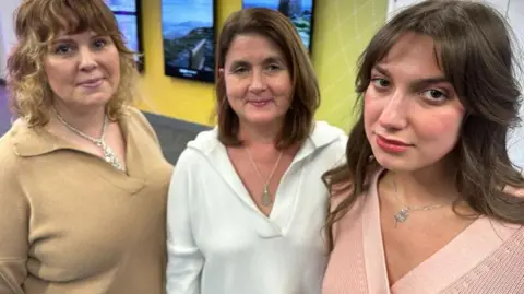 Three women who were on Dragon's Den - Yana Smaglo and two of her employees who modelled the clothes. All three wear knitwear and silver necklaces.