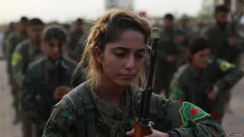 Getty Images Fighters from the Syrian Democratic Forces attend a funeral of fellow fighters