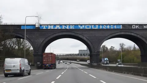 Getty Images Thank you NHS graffiti over bridge on M25