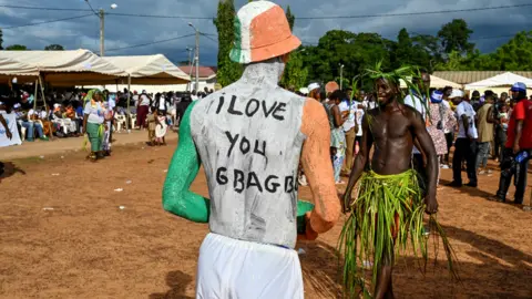 AFP A man with "I Love Gbagbo" painted on his back in Mama, Ivory Coast - Sunday 27 June 2021