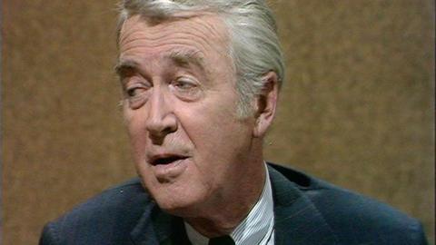 A close up of James Stewart speaking in the studio.