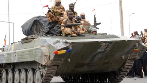 AFP Chadian soldiers returning from Mali sit on a tank during a procession through the capital N'Djamena - 2013