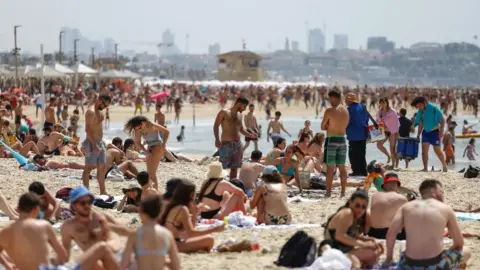 Reuters people enjoy the beach in tel aviv, 23 april