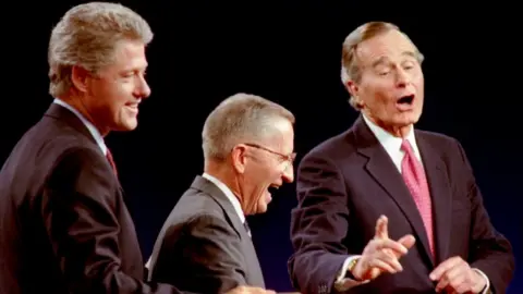 Reuters Democrat Bill Clinton (L), Independent Ross Perot (C) and President George Bush during their debate on 19 October 1992