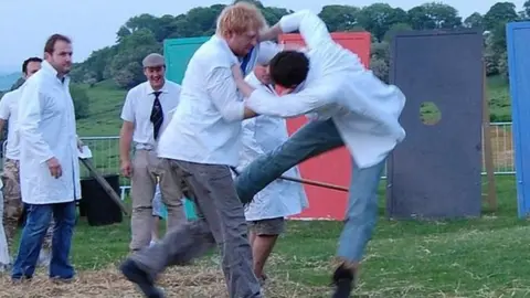 Two men compete at shin-kicking