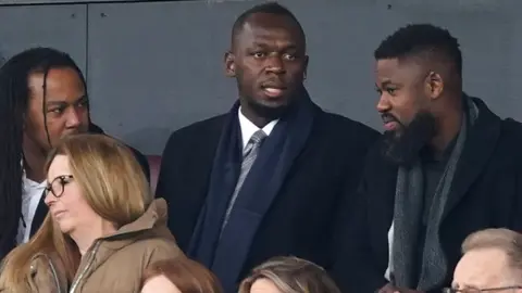 PA Media Usain Bolt in the director's box during the Emirates FA Cup quarter-final match at Old Trafford, Manchester