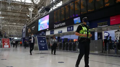 Reuters Police officer in face mask walks through empty Waterloo station