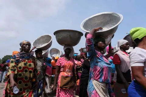 Reuters Head porters march in the streets on the second day of protests over recent economic hardships, in Accra, Ghana, June 29, 2022