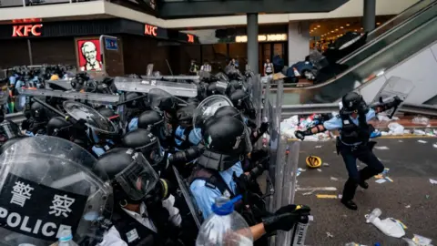 Getty Images A police officer throws a teargas canister during a protest on June 12, 2019 in Hong Kong China.