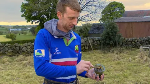 James Bell holding a jar of resin he made ahead of the tug-of-war competition at Balmoral Show.