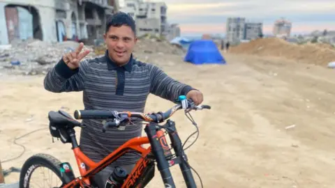 Al Madoun family Ahmed al-Madoun poses with a bike. 