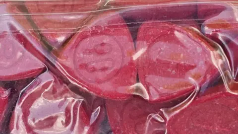 Cheshire Police Large bag of red pills.