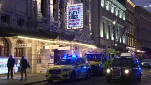 An ambulance, an ambulance and a taxi outside the Noel Coward Theatre where Sir Ian McKellen fell