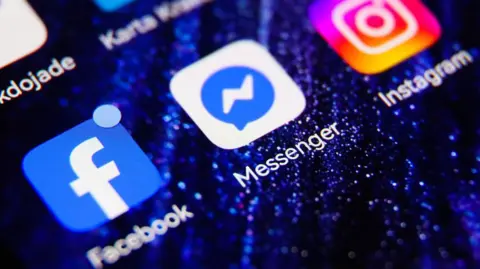 Close-up of Facebook, Messenger and Instagram app icons on a smartphone screen.