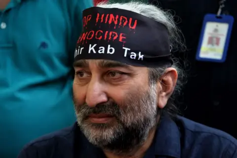 Getty Images Sushil Pandit, a Kashmiri pandit activist, participates in a protest demanding justice for the exodus of Kashmiri Pandit community who fled a rebellion in Muslim-majority areas in Kashmir valley during 1990's, in New Delhi, India on April 1, 2022