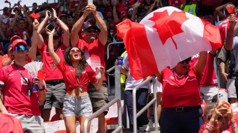 IMAGN IMAGES/Reuters Canada fans inside the stadium waving a flag and cheering