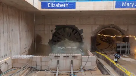 A boring machine is digging through a tunnel named Elizabeth