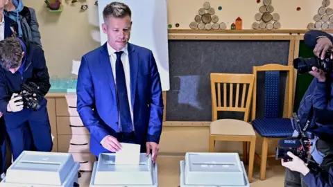 Reuters A man in a suit votes