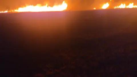 Surrey Fire and Rescue A field on fire at night