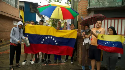 Paola and Miguel Sarzalejo with other protesters