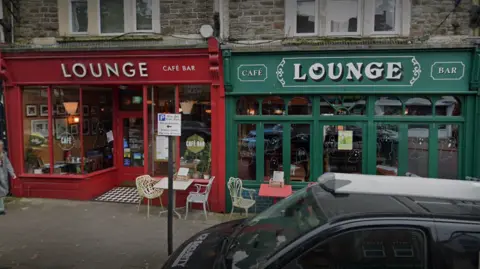 The exterior of The Lounge on North Street, Bedminster. The sign reads 'Lounge, Cafe Bar' and there are seats and tables outside.