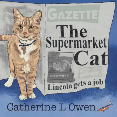 Catherine L Owen/Blue Poppy Publishing An illustrated book cover featuring a ginger cat with a blue collar standing in front of a newspaper with the headline "The Supermarket Cat". Beneath the headline is an illustration of the cat on top of a box of screenwash. Below that is a sub-headline, which reads "Lincoln gets a job." The background of the illustration is blue and the author's name - Catherine L Owen - is featured at the bottom of the illustration in black writing.