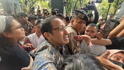 BBC/Haryo Wirawan Nadiem Makarim looks emotional as he pushes through a crowd of people