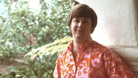 Brian Wilson wearing a red shirt in an old photo