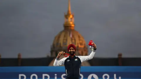 Getty Images PARIS, FRANCE - SEPTEMBER 04: Harvinder Singh of Team India, gold medalist, poses for pictured after winning the Men's Individual Recurve Open Gold Medal on day seven of the Paris 2024 Summer Paralympic Games at Esplanade Des Invalides on September 04, 2024 in Paris, France. (Photo by Steph Chambers/Getty Images)
