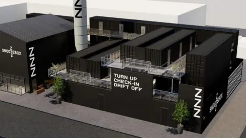 Snoozebox Artist's impression of how a complex of black metal shipping containers, stacked and arranged in a rectangular shape, could look. The company's logo is written in white on the outside, along with an advertising slogan "turn up, check-in, drift off".