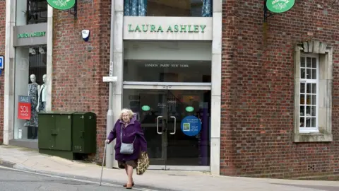 Getty Images Lady walks out of Laura Ashley