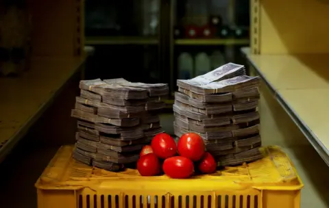 Reuters A kilogram of tomatoes next to 5,000,000 bolivars