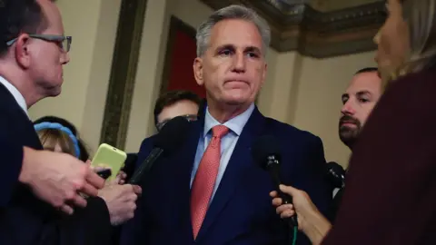 Getty Images Kevin McCarthy surrounded by members of the press