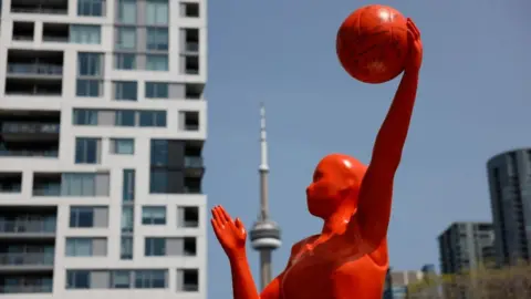 Getty Images A 12-foot-tall sculpture of the WNBA logo is pictured at the Stackt Market in Toronto ahead of Canada's first WNBA game set for May 13, 2023. Toronto Star/Lance McMillanMay-10-2023