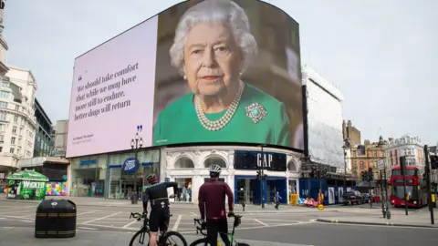 PA Media An image of Queen Elizabeth II and quotes from her broadcast on Sunday to the UK and the Commonwealth in relation to the coronavirus epidemic are displayed on lights in London"s Piccadilly Circus.