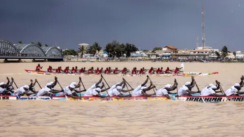 AFP Two pirogue teams race each other along the Senegalese River in Saint-Louis, Senegal - Saturday 23 July 2022