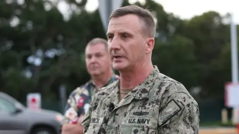 Getty Images Rear Admiral Robert Chadwick answers questions at a press conference