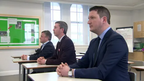 BBC Carl Whyte, Mal O'Hara and John Finucane went to school together and are stood for different parties in the local government elections.