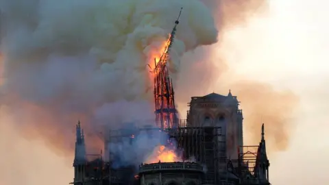 Getty Images Notre Dame's spire collapses in a fire on 15 April 2019