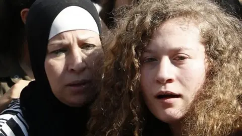 AFP Ahed Tamimi (R) and her mother Nariman