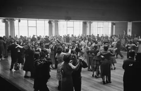 Thurston Hopkins/ Getty Images Dancers at a charity ball in Scotland, where French fashion designer Christian Dior's new collection was shown.