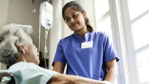 Getty Images Elderly woman being treated in hospital