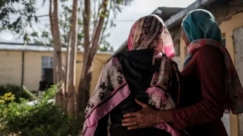 Getty Images Two women at a centre for survivors of sexual assault in Tigray