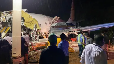 EPA Indian Civil Defence handout photo shoes the wreckage of Flight IX 1134 at Calicut airport (7 August 2020)