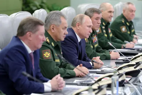 Getty Images Putin and his defence chiefs watch a hypersonic missile launch via video link in 2018